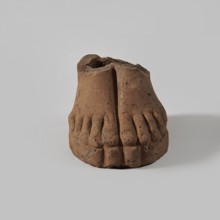 Fragment of a terracotta figurine showing two feet placed side by side on a flat, rounded base.,
