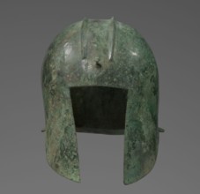 Bronze helmet with rectilinear cutouts for the eyes, nose, mouth, and chin, with two prominent