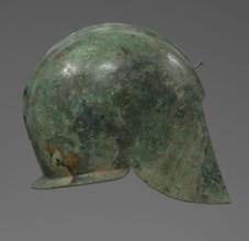 Bronze helmet with rectilinear cutouts for the eyes, nose, mouth, and chin; two prominent