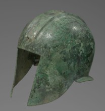 Bronze helmet with rectilinear cutouts for the eyes, nose, mouth, and chin; two prominent