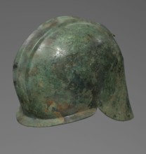 Bronze helmet with rectilinear cutouts for the eyes, nose, mouth, and chin; two prominent
