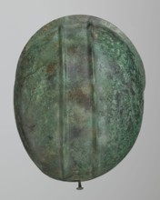 Bronze helmet with rectilinear cutouts for the eyes, nose, mouth, and chin; the helmet has two