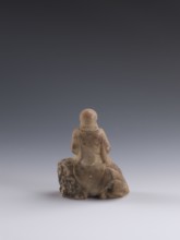 Luohan on a lion;, arhat iconography; lion iconography; figurine; Chinese art; Chinese culture;