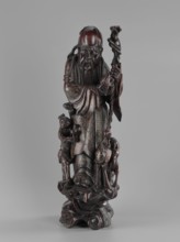 Deity of Longevity Shouxing/Shoulao holds a long traveling staff and a peach of immortality; his