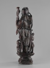 Deity of Longevity Shouxing/Shoulao holds a long traveling staff and a peach of immortality; his