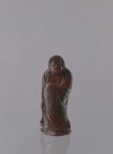 Daruma, unknown sculptor, Japanese, Meiji period 1868–1912, ceramics figurine of a male Buddhist