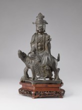 Buddhist deity on a buffalo, on a base; figurine; Chinese; Chinese Buddhism; lotus iconography;
