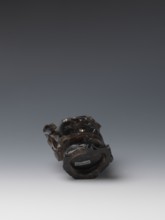 Vase on base, carved ornaments of flowers, birds, and stylized rocks; wooden oval base on three