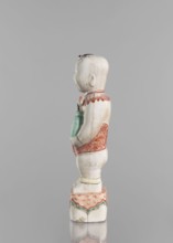 One of the Hehe Er Xian brothers holding a vase with lotus buds; maker, Chinese porcelain