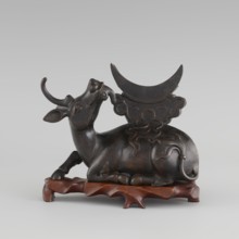 Mirror with TLV decoration on a pedestal in the form of a qilin on a base. Chinese, Qing dynasty