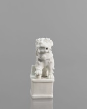 Foo lion figurine with a ball;, lion iconography; ceramics; blanc de Chine porcelain; figurine;