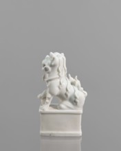 Fo lion foo dog figurine with a ball; maker, 18th century China; blanc de Chine porcelain; subject: