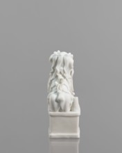 Fo lion figurine with a ball;, lion iconography; ceramics; blanc de Chine porcelain; figurine;