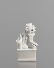 Fo lion figurine with a ball;, lion iconography; blanc de Chine porcelain; animal figurine; Chinese
