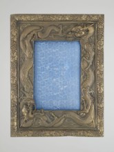 Frame with glass and raised back support covered with blue silk with floral patterns; originally
