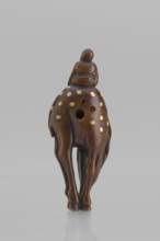 Netsuke in the shape of Fukurokuju riding a deer. The deer has all its legs put together so that
