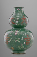 Vase, calabash form, 18th century China, Qing dynasty. Porcelain vessel with decoration on a green