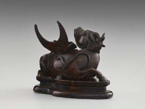 Mirror pedestal — lying unicorn on base; carved wooden base; qilin unicorn iconography; crescent