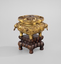 Incense burner with a cover on a base. Incense burner modeled on the ding type with a four-petal