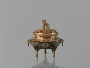 Incense burner koro of the ding type with a cover. Incense burner with two handles knobs, on three