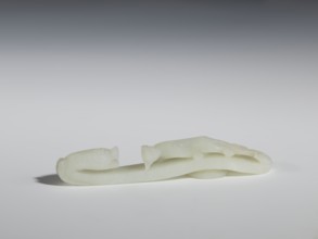 Belt clasp, Chinese, Qing dynasty 1644–1911. 18th–19th century. Milky-white jadeite, slightly