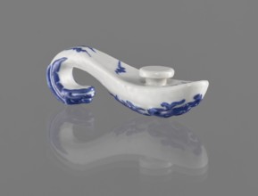 Belt clasp, Chinese; 19th century. Porcelain belt buckle decorated with navy blue overglaze enamel