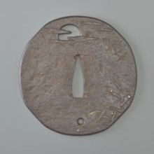 Crossguard tsuba, Kaneie,  school craftsman author. Japanese iron oval tsuba with an irregular