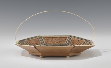 Basket. Octagonal shallow wooden basket with an ivory rim and handle. Inside the basket is a relief