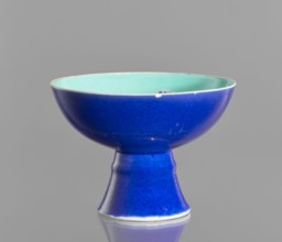 A porcelain footed bowl, Chinese, 19th century Qing Dynasty. Cobalt blue exterior glaze, green