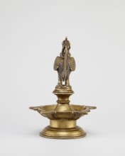 Oil lamp, Round base with a pentagonal vessel for oil topped by a bird figurine rooster/swans/geese