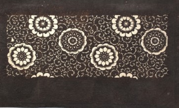 Katagami dyeing stencil with a motif of stylized flower rosettes and plant tendrils kawari kamon ni