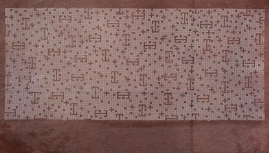 A katagami dyeing stencil cut into a pattern composed of small crosses, squares, and lines against