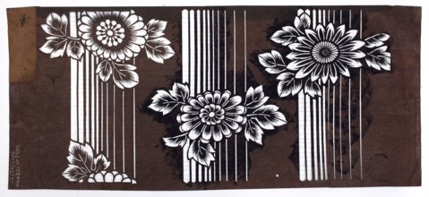 A katagami dyeing stencil cut into a pattern of chrysanthemum flowers against a background of