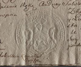 Round seal impression of the town of Kleszczele, Podlaskie Voivodeship. A shield supported by two