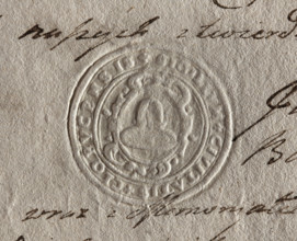 Round seal impression of the town of Klobuck, Kraków Voivodeship. On a decorative Baroque shield, a