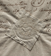 Round seal impression of the town of Losice. Under the crown in a rim of palm branches, a female