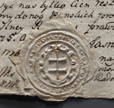 Round seal impression of the town of Malogoszcz. In a decorative cartouche, a double cross — the