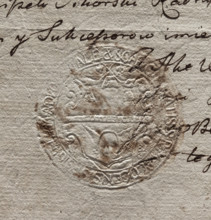 Round imprint of the city seal of Plock. In a decorative cartouche, a wall with an open gate and