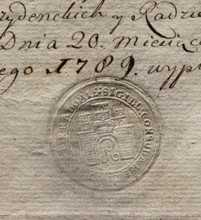 Round seal impression of the city of Radom. City wall with an open gate; in the gate the letter R,