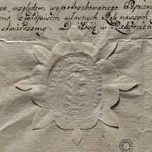 Oval seal impression of the town of Rakoniewice. In the central field, a tree trunk with knots