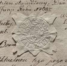 Round imprint of the seal of the town of Stopnica. In a decorative cartouche a key - tooth up.