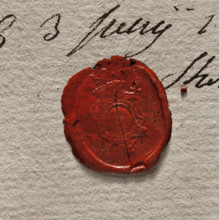 Round imprint of the seal of the town of Stopnica. In a decorative cartouche a key—bit upward.