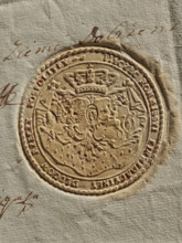 Round seal of the Debt Liquidation Commission of the Republic of Poland. On the ermine cloak, under