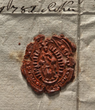 Oval wax impression of the seal of the town of Wolsztyn. In an oval rim with rays, the Virgin Mary