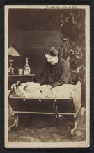 Portrait of Celina Dominikowska née Tretery (?–1910) with Kordzio in a cradle. Photographer: F.