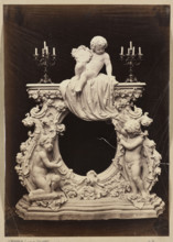 Photograph of a sculpture by Wiktor Brodzki showing a neo-rococo fireplace frame with three putti;