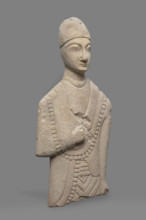 Fragment of a votive figure of a man. The fragment depicts a standing man dressed in a tutulus and