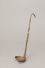 Shallow dipper with a quadrilateral handle, narrowed at the top. The end of the handle is in the