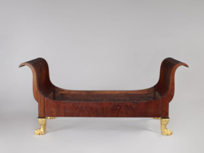Bed with animal-paw legs in Empire style for bedrooms. Mahogany bed with S-shaped outward-curving