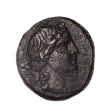 bronze coin, Pantikapaion; obv.: head of young Dionysus in an ivy wreath facing right; reverse: bow